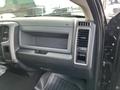 The interior dashboard of a 2015 RAM 1500 featuring a large glove compartment and air conditioning vents on the side