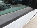 A 2017 Ford F-250 SD with a silver exterior viewed from the side showing a close-up of the door edge and window trim