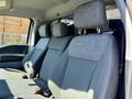 Interior view of a 2023 Ford F-550 featuring two front seats with grey upholstery and headrests
