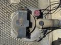 A metal cover with a latch and an attached hose for a 2009 International 7500 vehicle located on a textured surface
