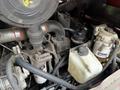 A 2012 Toro Groundsmaster engine showing various components including hoses, filters, and a coolant reservoir