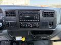 Dashboard of a 2008 Ford F-750 featuring a car stereo buttons and controls air vents and a space for additional devices