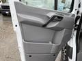 Interior door panel of a 2016 Mercedes-Benz Sprinter in gray plastic with a handle and a storage compartment
