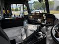 Interior view of a 2010 Peterbilt 320 showing the dashboard with various switches levers and controls for operating the vehicle
