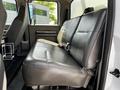 Inside a 2009 Ford F-550 the back seat is upholstered in black leather with a seatbelt and features a simple design with no visible armrests or additional features