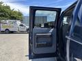 A 2014 Ford F-250 SD with the driver's side door open showing the interior door panel and handle