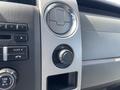The interior dashboard of a 2012 Ford F-150 featuring controls for audio and climate as well as a 12V power outlet