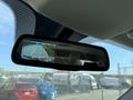 Rearview mirror displaying a backup camera feed with guidelines for parking and visible road behind a 2019 RAM 1500 Classic