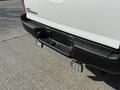 A white 2015 Toyota Tacoma truck with a black rear bumper and LED fog lights