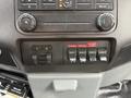 Dashboard controls of a 2013 Ford F-550 featuring various switches for auxiliary functions and climate controls