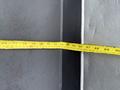 A measuring tape extended along a surface of a 2004 Ford F-750 showing measurements in inches