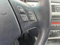 A close-up view of the steering wheel of a 2011 BMW 3-Series with various control buttons visible on the left side