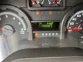 Dashboard of a 2010 Ford Econoline showing the trip meter at 34.8 and odometer reading 143427 with various gauges and indicator lights
