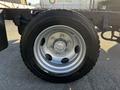 A close-up view of a silver alloy wheel on a 2017 Isuzu NQR showing the tire tread and wheel nuts