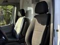 Interior of a 2016 Mercedes-Benz Sprinter showing two front seats positioned side by side with fabric upholstery in gray and black