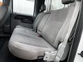 Interior view of a 2007 Ford F-550 showing a gray bench seat with fabric upholstery and seatbelts