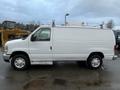 A white 2014 Ford Econoline van with a sliding side door and roof-mounted accessories