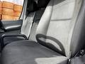 Interior view of a 2017 Mercedes-Benz Sprinter showing the driver's seat and a part of the passenger seat in fabric upholstery