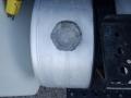 A silver fuel tank with a textured cap and visible labels is attached to the side of a 2014 International Durastar truck