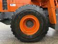 A large black tire with an orange rim from a 2018 Doosan DL300-5 heavy equipment vehicle