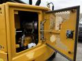 A 2024 Caterpillar 306 excavator with an open engine compartment revealing the engine and components inside
