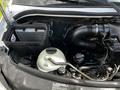 A 2012 Mercedes-Benz Sprinter engine compartment showing the air filter housing and various engine components including hoses and fluid reservoirs