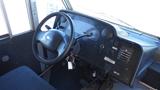 Interior view of a 2006 Ford Econoline showing the steering wheel dashboard and driver's seat with keys hanging from the ignition