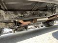 View of the underside of a 1962 Ford F-100 showing the exhaust system and chassis components