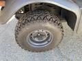 A close-up view of a tire from a 2018 Kubota RTV-X 1100 C featuring a rugged tread pattern and a metallic rim
