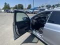 A 2017 Acura TLX with the driver's door open displaying the interior design and dashboard controls