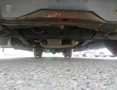 Underside view of a 2020 Chevrolet Express showing the chassis exhaust system and undercarriage components