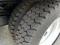Close-up of a rugged tire with deep treads on a 2018 Isuzu NPR showcasing its durability and traction features