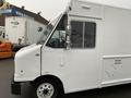 A 2012 Ford Econoline cargo van in white with a large sliding side door and front windows