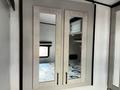 A two-door mirrored cabinet with sleek silver frames and black handles