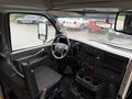 Interior view of a 2020 Chevrolet Express showing the driver's seat dashboard and controls