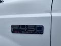 Close-up of a badge on a 2003 Ford F-450 Super Duty truck reading F-450 XL Super Duty