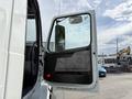 A 2012 Volvo VNL truck with its door open showcasing the interior features and controls