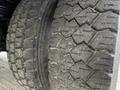 Close-up of two worn tires from a 2016 Ford F-550 showing distinct tread patterns and signs of usage