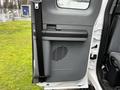 Interior door panel of a 2013 Ford F-650 featuring a black armrest and a vent with horizontal slats