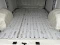Interior of a 2018 RAM Promaster van showing the empty cargo area with a metal floor and two wheel wells on either side