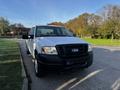 2008 Ford F-150 XL in white with a black front grille parked on a street