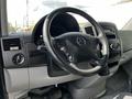 Interior view of a 2012 Mercedes-Benz Sprinter showing the steering wheel dashboard and control panel