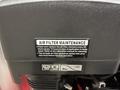 A close-up of a Magnum 4000 Hot Water Pressure Washer showing a label for air filter maintenance instructions