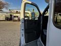 A 2017 Chevrolet Express van with its driver's door open revealing the interior features such as the seat and panel