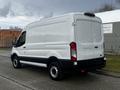 A white 2020 Ford Transit van parked with a high roof and rear cargo doors closed