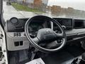 Interior view of a 2021 Mitsubishi FE showcasing the steering wheel dashboard and control panel