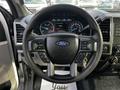 Steering wheel of a 2017 Ford F-550 with controls and Ford emblem visible dashboard display in the background