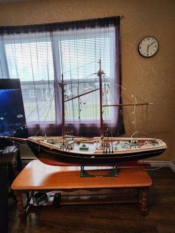 A detailed 1974 model sailboat displayed on a table with multiple sails rigged and various features on the deck priced at two thousand dollars or best offer