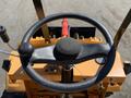 Top view of the steering wheel and controls of a 2024 Traner TR 45 tractor with an orange body and metal components