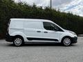 A white 2014 Ford Transit Connect van is shown from the side with a sliding door and five-spoke wheels
